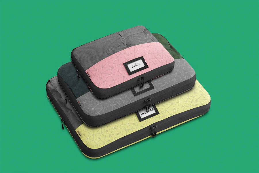 Three compression packing cubes stacked on top of each other, made from recycled materials. Save space and stay organised while traveling with Zoomlite's compression packing cubes.