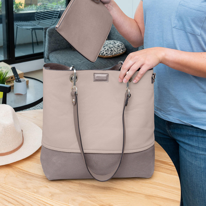 Lady placing a wristlet into a Faux leather Gisele handbag#colour_bronzebge