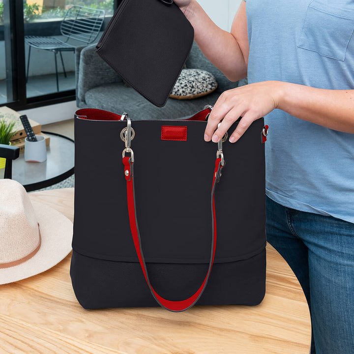 Lady placing a zippered pouch into a vegan leather black Gisele handbag#colour_scarletblk